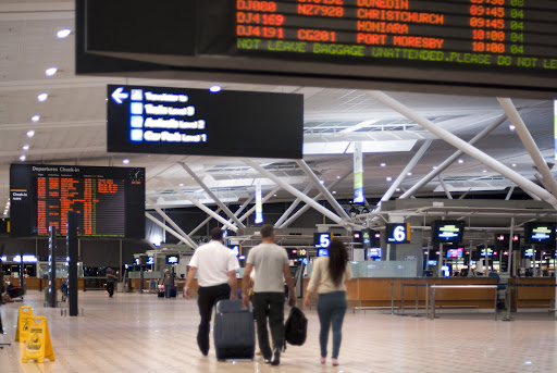 Interior View or Airport Terminal with Travelers Carrying Luggage List of Harry Reid Airport Lounges
