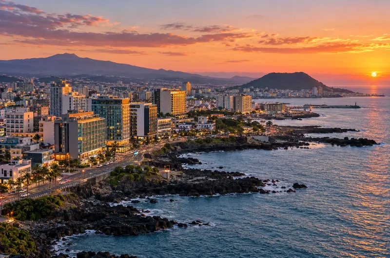 Jeju City coastal business skyline at sunset